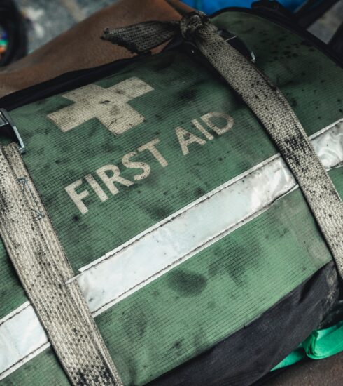 green and black first aid bag